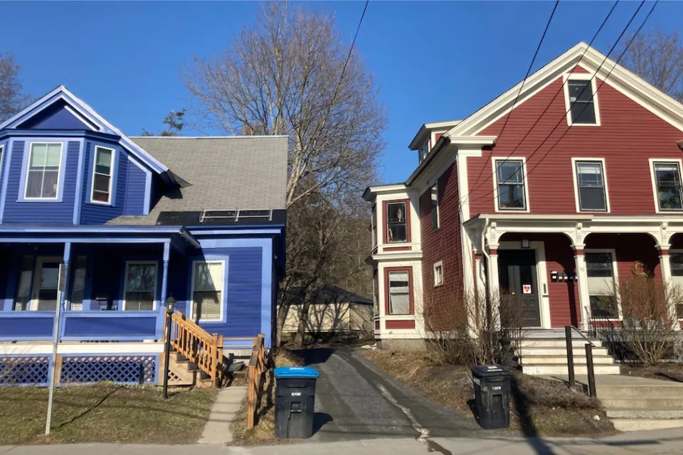 Blue and red colonial-style multifamily homes in Vermont.